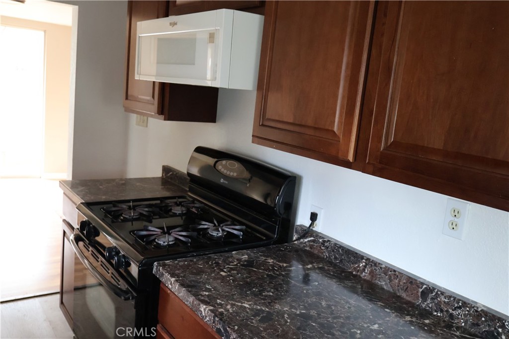 1410 4th Corning, CA 96021 - Photo 12 of 26 a kitchen with a stove and a microwave