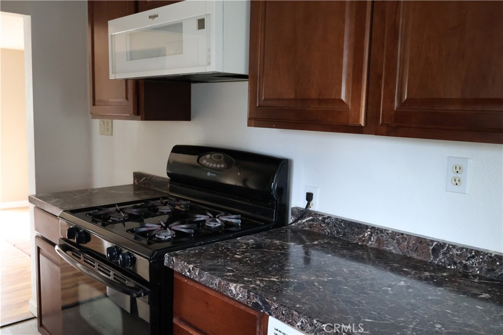 1410 4th Corning, CA 96021 - Photo 16 of 26 a kitchen with a stove and a microwave