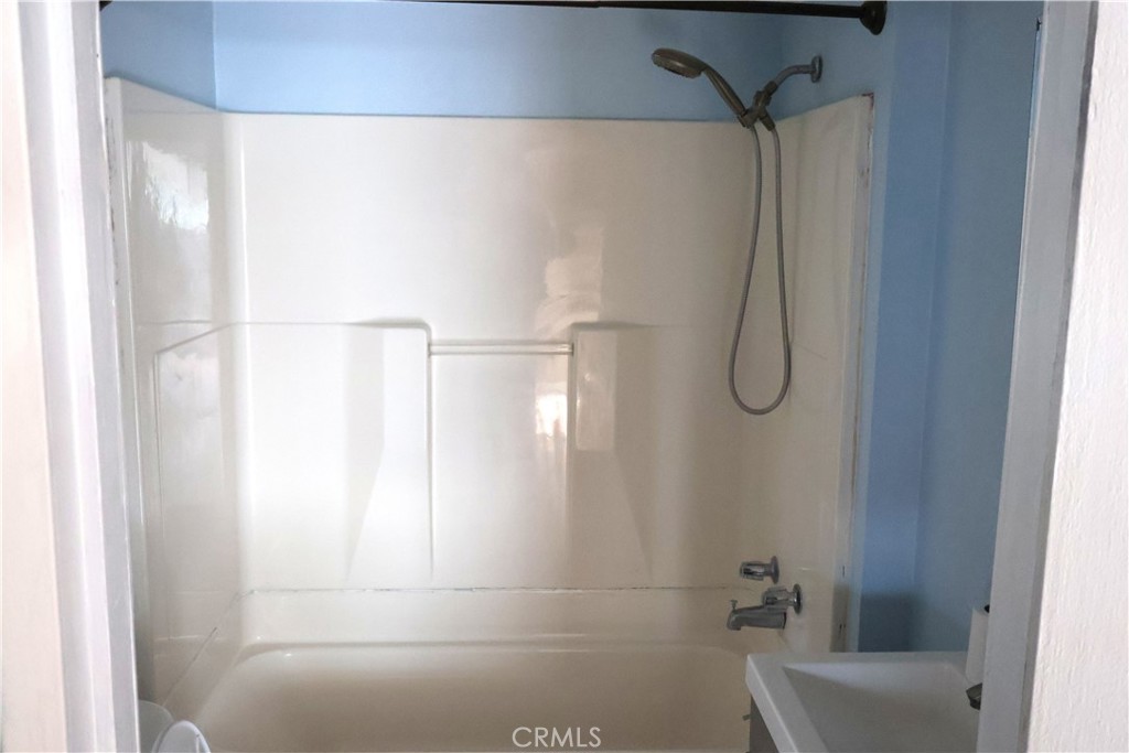 1410 4th Corning, CA 96021 - Photo 21 of 26 a bathroom with a shower and a toilet