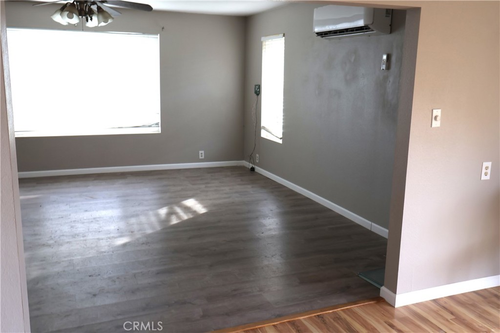 1410 4th Corning, CA 96021 - Photo 22 of 26 an empty room with wooden floor and windows
