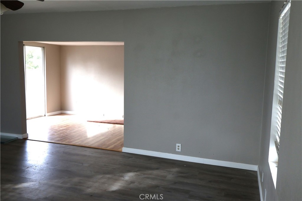 1410 4th Corning, CA 96021 - Photo 10 of 26 an empty room with wooden floor and windows