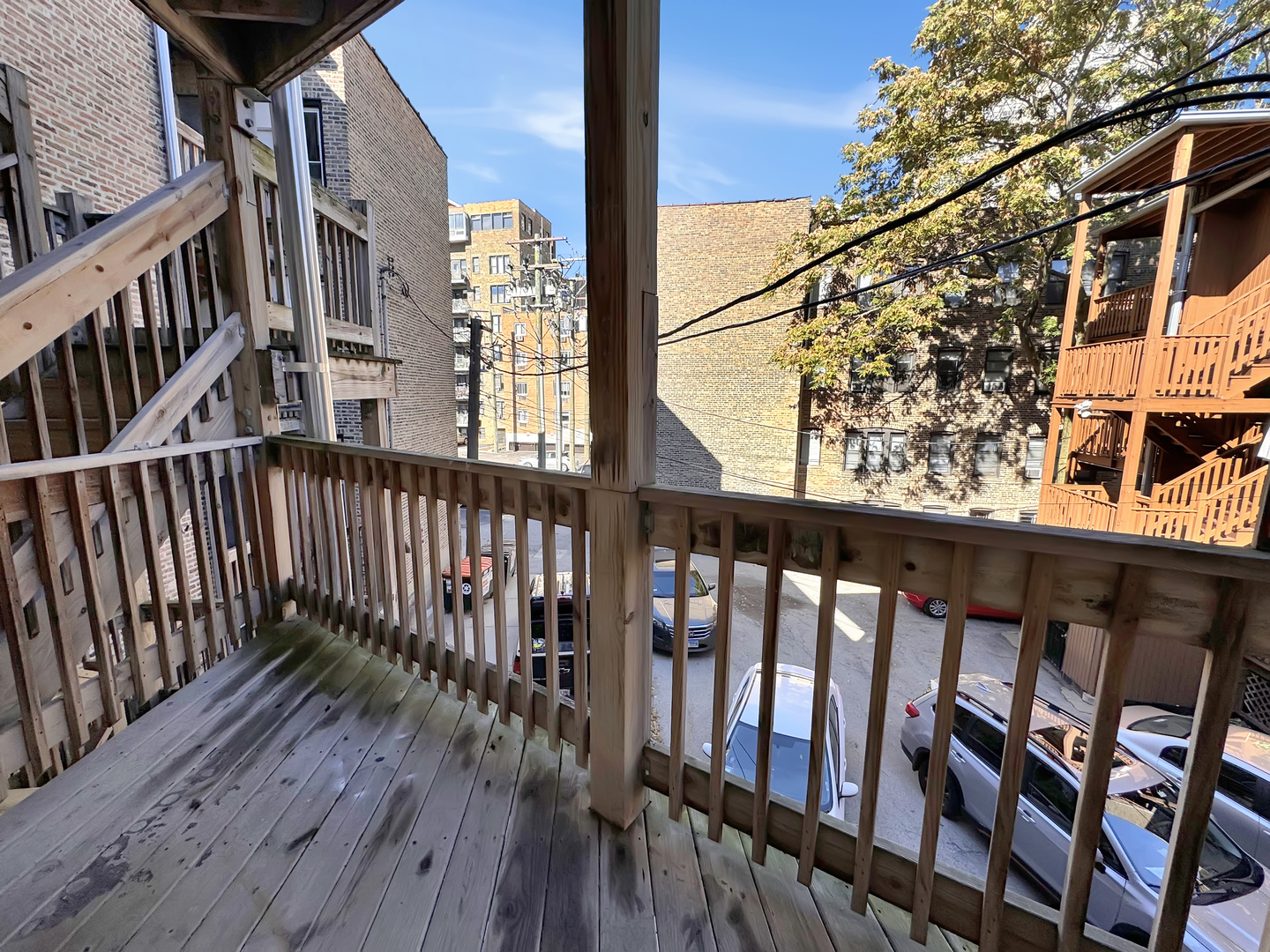 710 West Grace Street, Unit 2 Chicago, IL 60613 - Photo 12 of 12 a view of a balcony with wooden floor