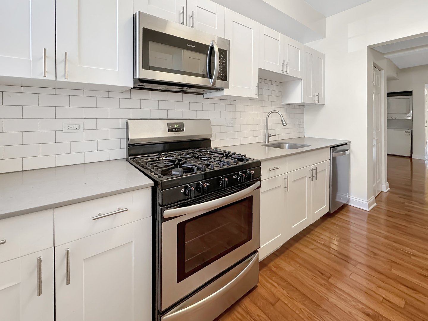 710 West Grace Street, Unit 2 Chicago, IL 60613 - Photo 6 of 12 a kitchen with cabinets stainless steel appliances and wooden floor