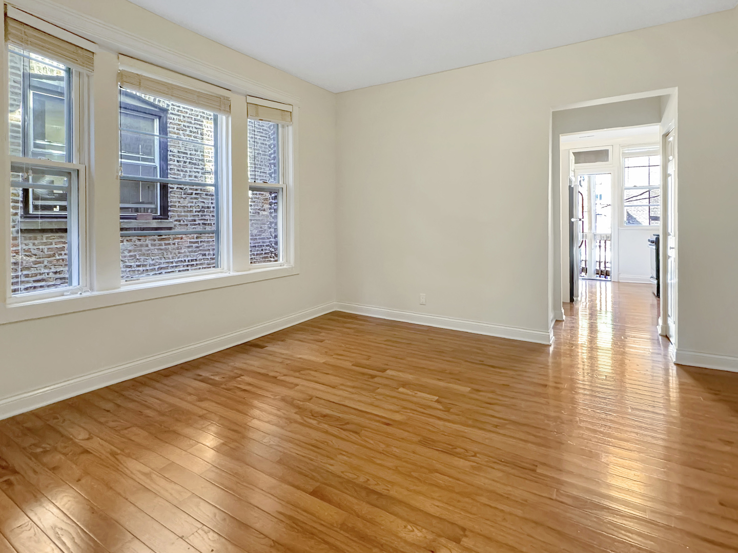 710 West Grace Street, Unit 2 Chicago, IL 60613 - Photo 8 of 12 a view of empty room with wooden floor and fan