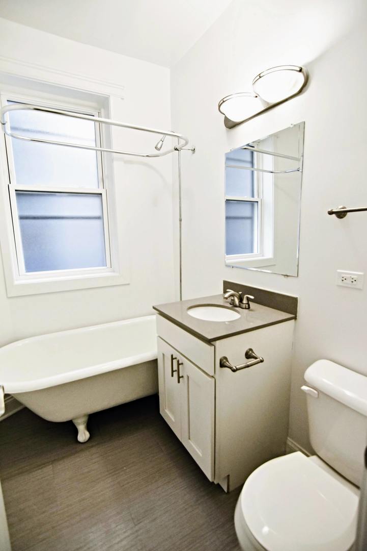 710 West Grace Street, Unit 2 Chicago, IL 60613 - Photo 10 of 12 a bathroom with a sink a toilet and shower