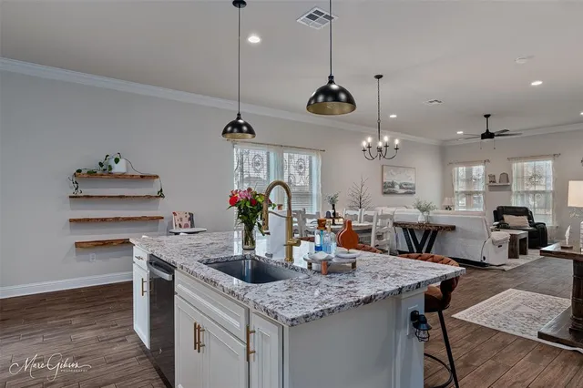 a kitchen with a counter space a sink and cabinets