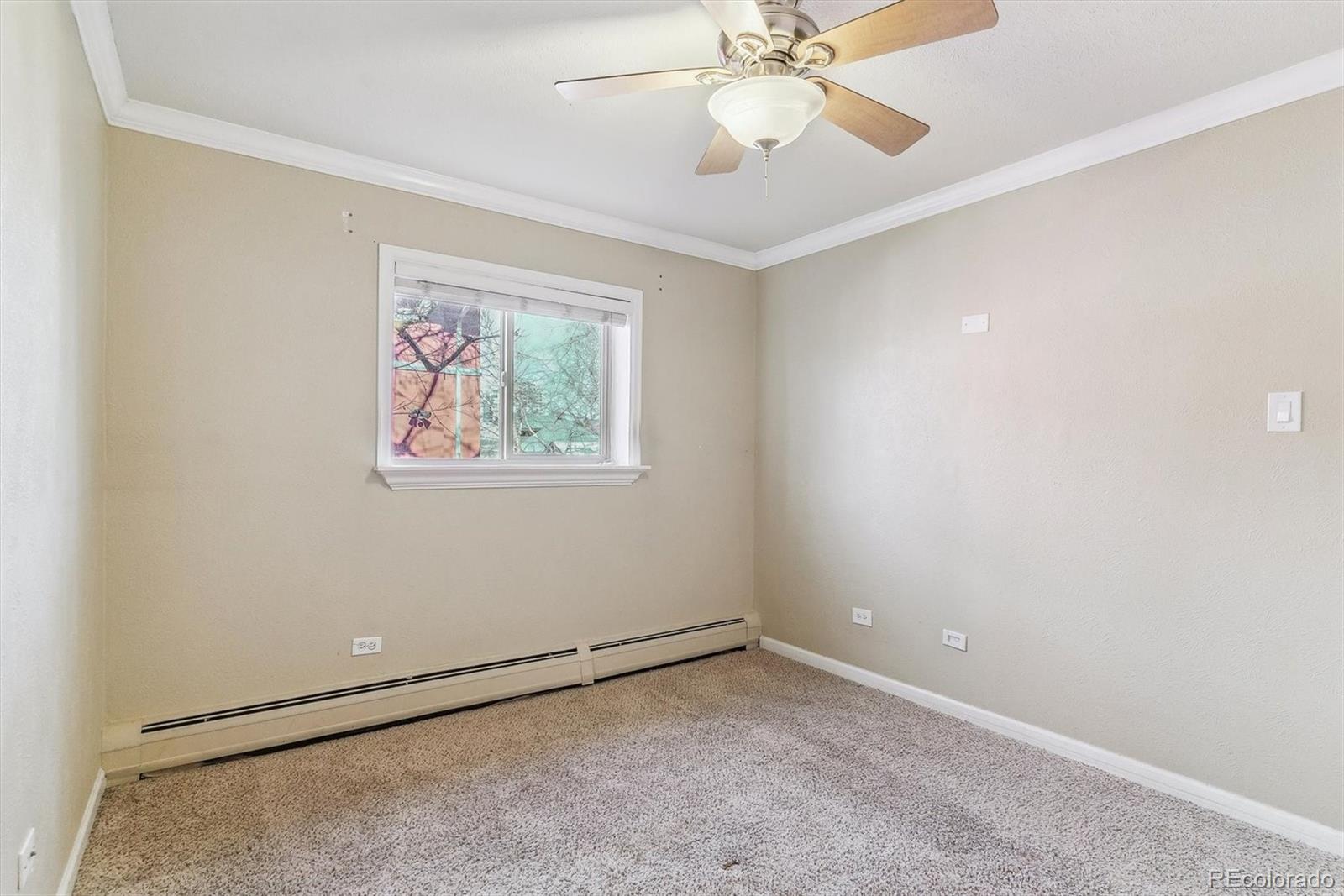 1330 Elizabeth Street, Unit 8 Denver, CO 80206 - Photo 13 of 15 an empty room with a window and a fan