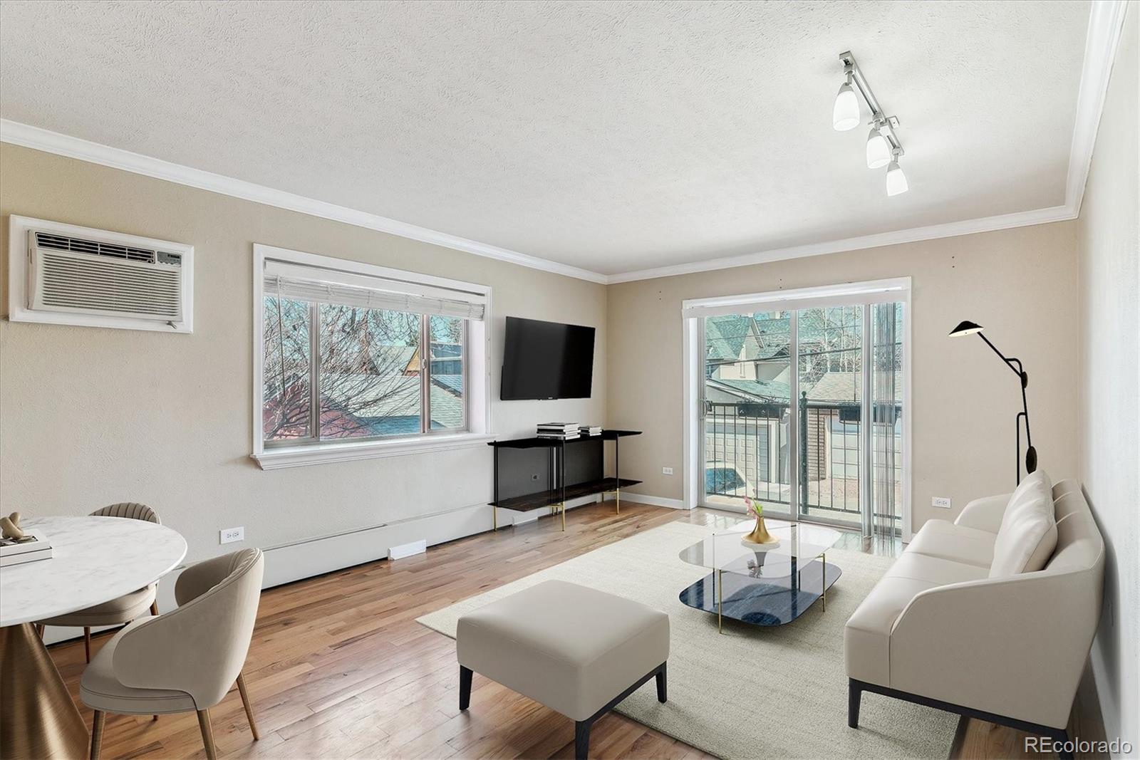 1330 Elizabeth Street, Unit 8 Denver, CO 80206 - Photo 5 of 15 a living room with furniture a flat screen tv and a large window