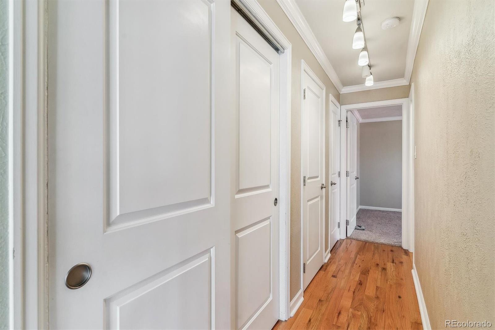 1330 Elizabeth Street, Unit 8 Denver, CO 80206 - Photo 9 of 15 a view of a hallway with wooden floor and closet