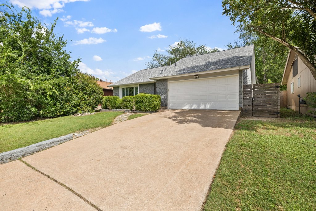 658 Mairo Street Austin, TX 78748 - Photo 38 of 40 A classic ranch-style home featuring a well-maintained driveway, mature landscaping, and an integrated garage.