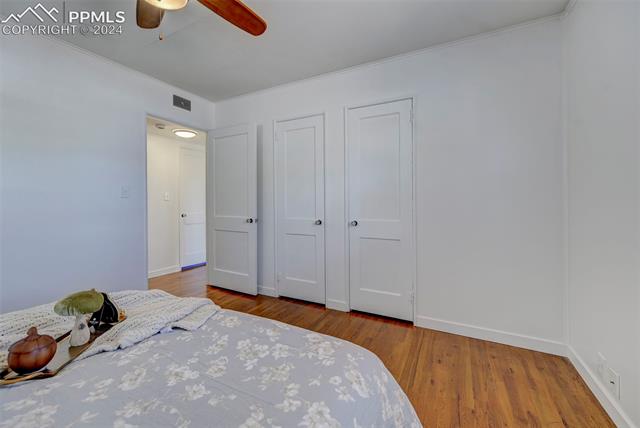507 East Cheyenne Road Colorado Springs, CO 80905 - Photo 15 of 25 Unfurnished bedroom featuring crown molding, ceiling fan, and light wood-type flooring