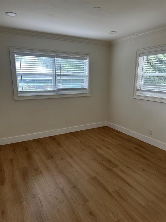 1242 Northeast 110th Street, Unit 2 Miami, FL 33161 - Photo 11 of 12 wooden floor in an empty room with a window