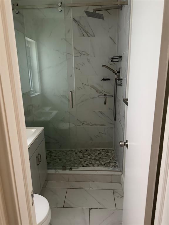 1242 Northeast 110th Street, Unit 2 Miami, FL 33161 - Photo 8 of 12 a bathroom with a shower and toilet