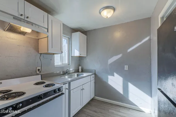 a kitchen that has a sink and a stove