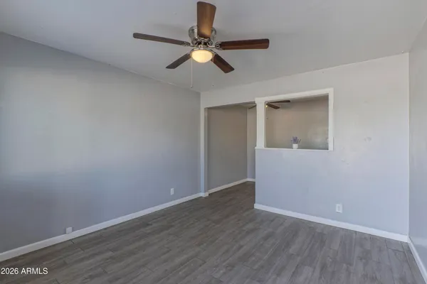 a view of an empty room with wooden floor