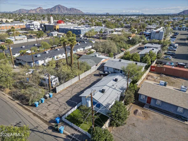 an aerial view of a house with a mountain