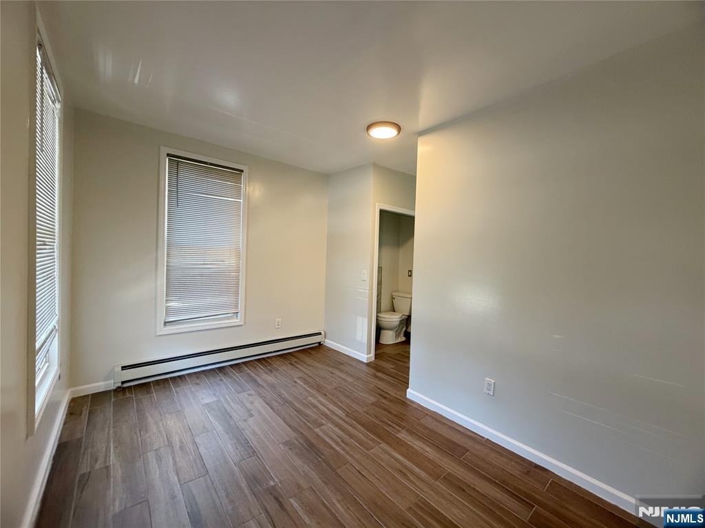 26 River Edge Road River Edge, NJ 07661 - Photo 6 of 10 an empty room with wooden floor and windows