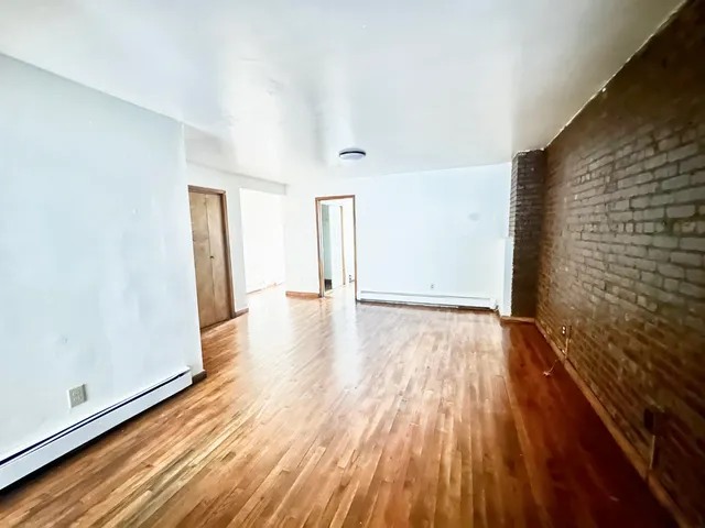 a view of a room with wooden floor