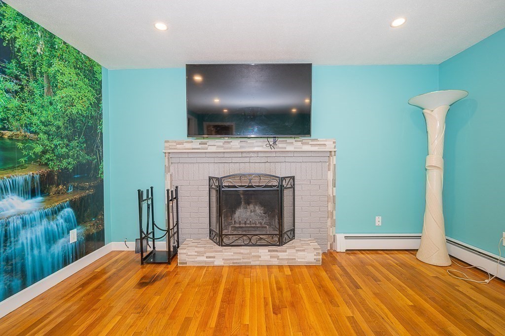 4 Kent Street Clinton, MA 01510 - Photo 11 of 39 a view of a livingroom with a fireplace and a fireplace