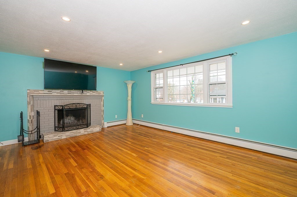 4 Kent Street Clinton, MA 01510 - Photo 12 of 39 an empty room with large windows and fireplace