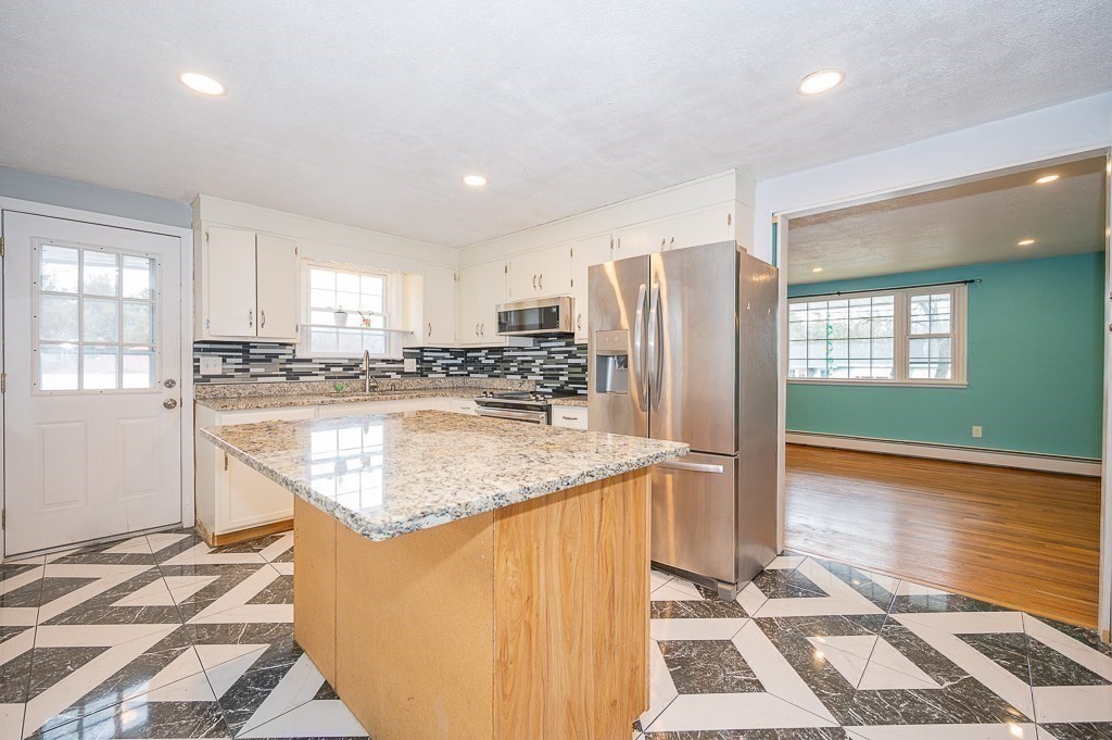 4 Kent Street Clinton, MA 01510 - Photo 15 of 39 a kitchen with stainless steel appliances granite countertop a refrigerator and a sink