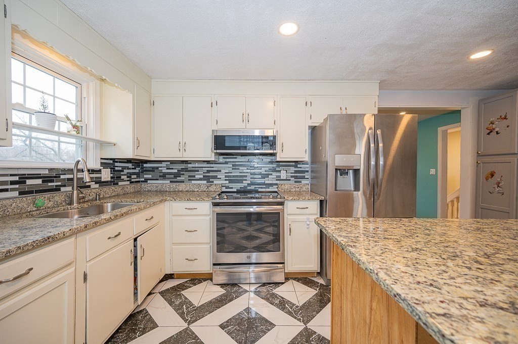 4 Kent Street Clinton, MA 01510 - Photo 16 of 39 a kitchen with granite countertop a sink stove and refrigerator