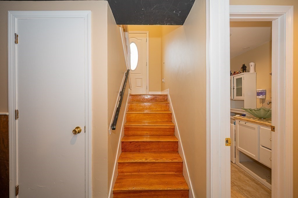 4 Kent Street Clinton, MA 01510 - Photo 28 of 39 a view of a hallway with wooden floor and a bathroom