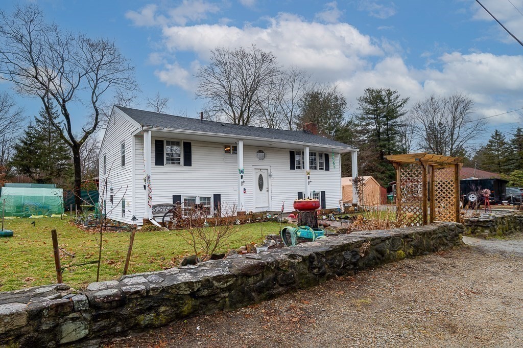 4 Kent Street Clinton, MA 01510 - Photo 3 of 39 a front view of a house with garden