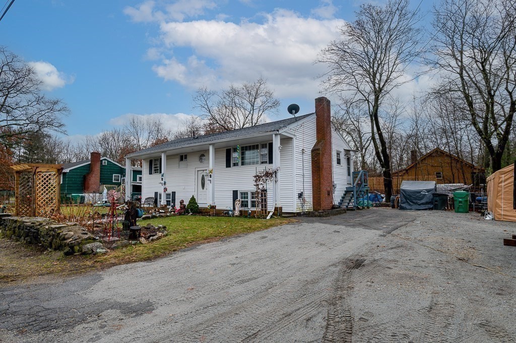 4 Kent Street Clinton, MA 01510 - Photo 4 of 39 a view of a white house with a big yard and large trees