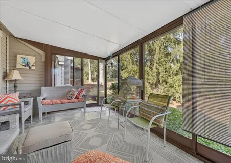 a view of a house with a yard and large tree