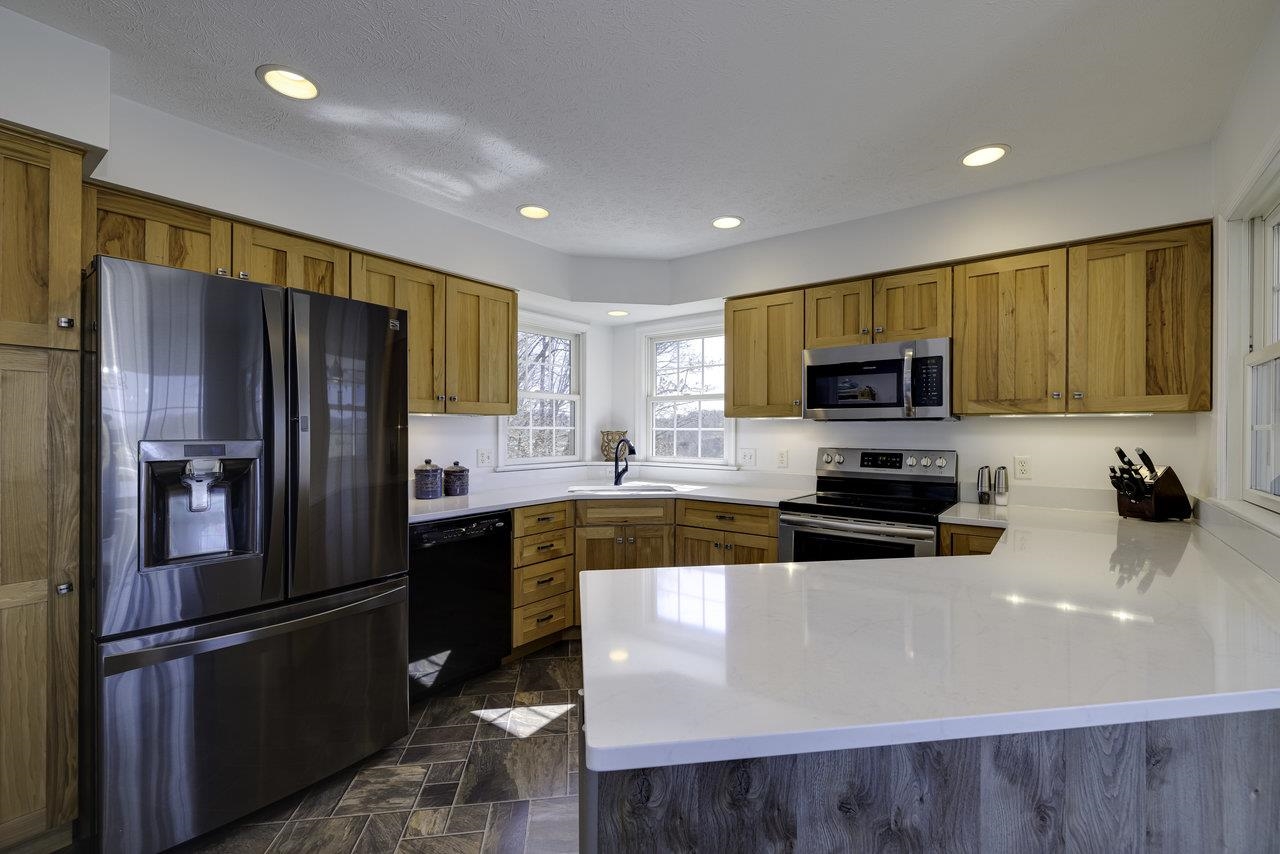 1709 Mt Solon Road Mount Solon, VA 22843 - Photo 11 of 75 a kitchen with stainless steel appliances granite countertop a refrigerator a stove top oven a sink dishwasher and wooden cabinets