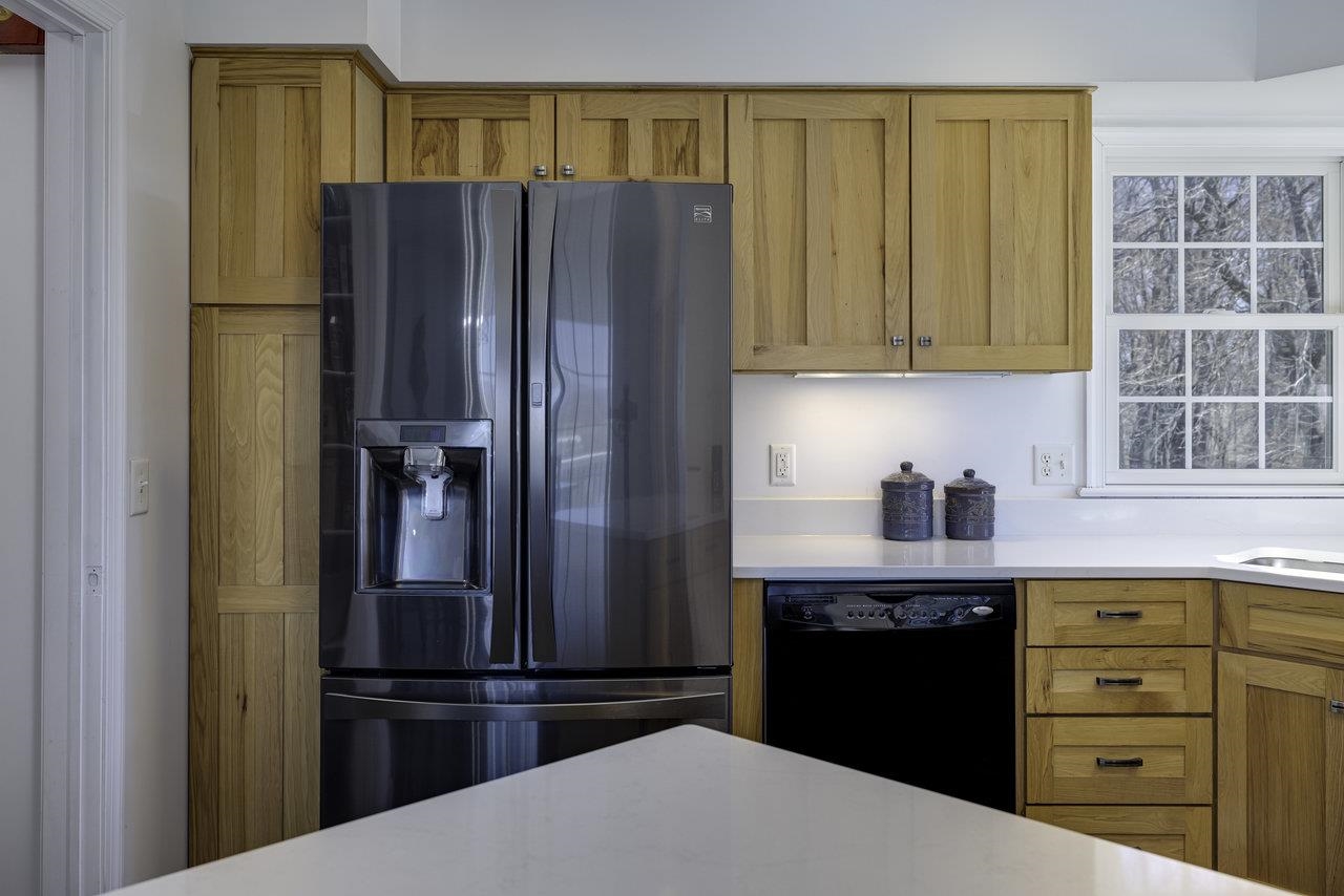 1709 Mt Solon Road Mount Solon, VA 22843 - Photo 12 of 75 a kitchen with granite countertop a refrigerator and a stove top oven