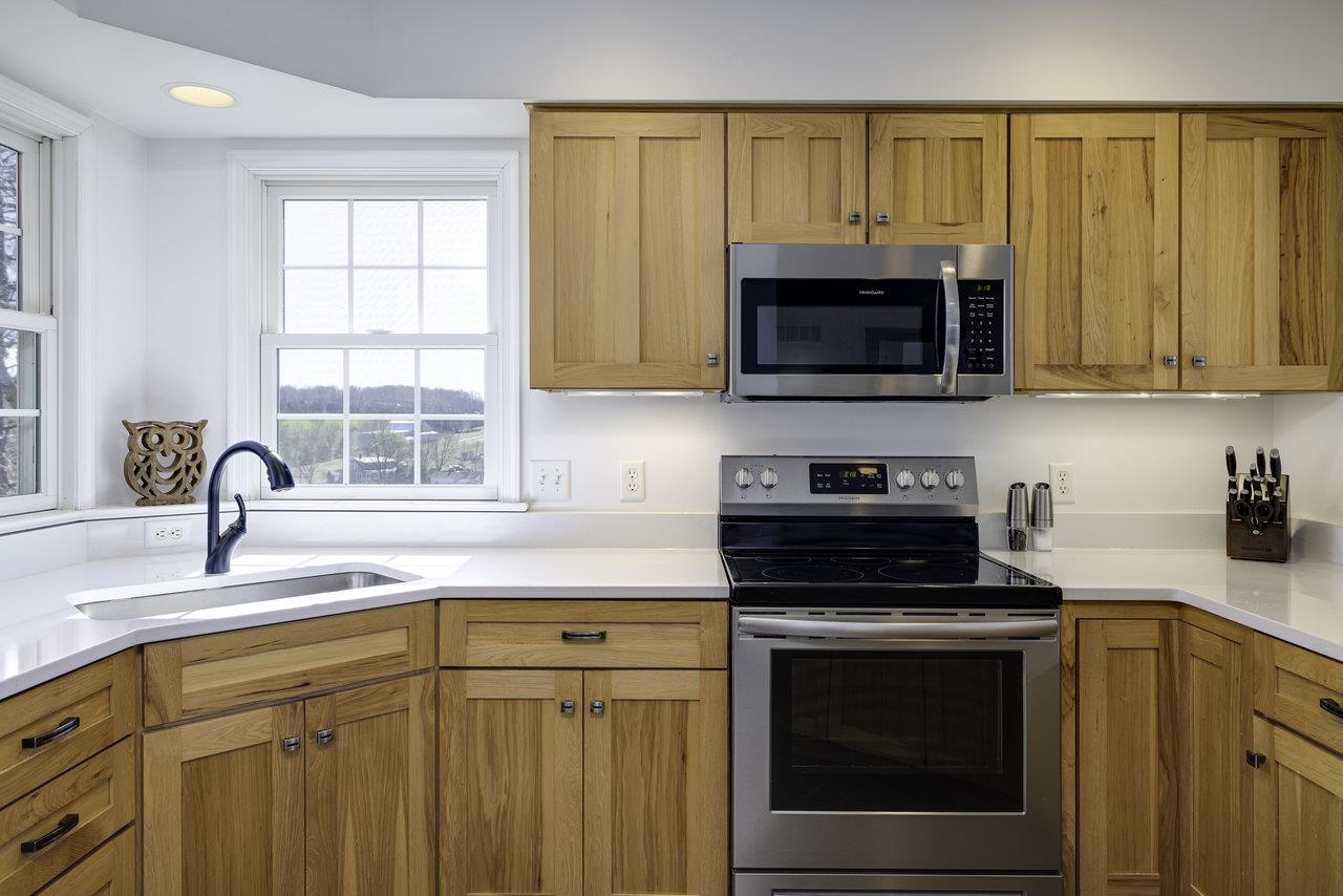 1709 Mt Solon Road Mount Solon, VA 22843 - Photo 13 of 75 a kitchen with granite countertop a stove a sink and a microwave