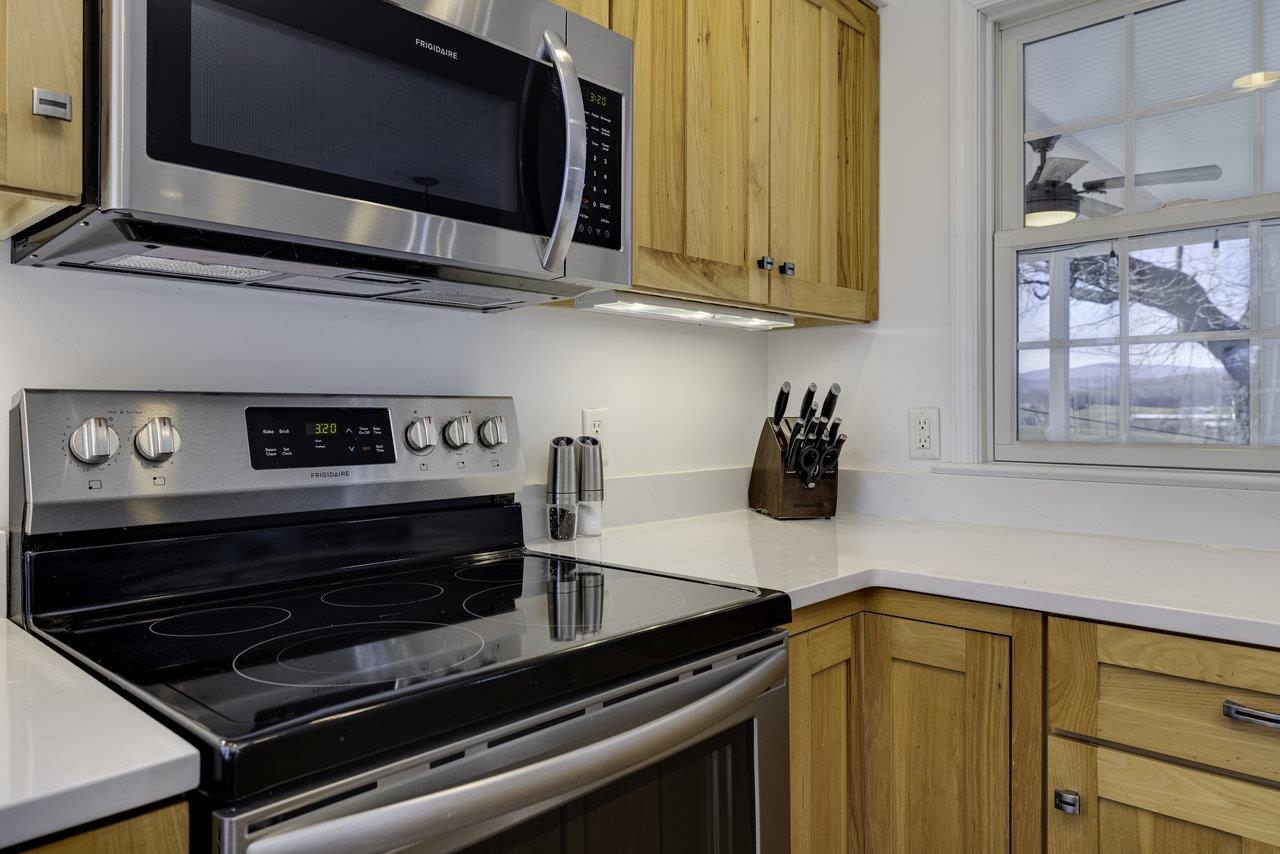 1709 Mt Solon Road Mount Solon, VA 22843 - Photo 15 of 75 a kitchen with stainless steel appliances a stove a microwave and cabinets