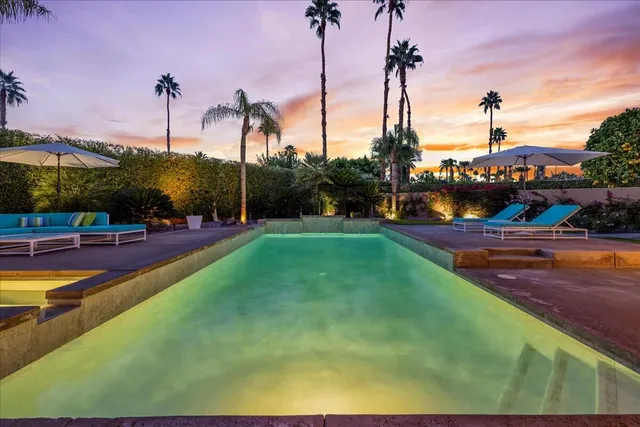 a dining room with furniture and a floor to ceiling window