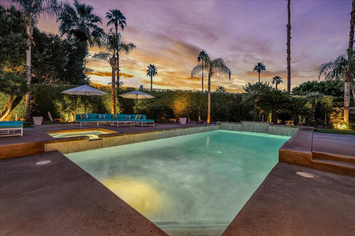 2 Silver Circle Rancho Mirage, CA 92270 - Photo 23 of 52 a view of a swimming pool with a yard and palm trees
