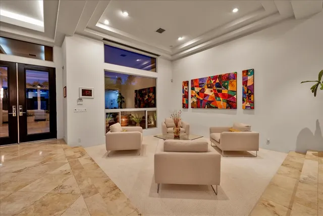 a view of a swimming pool with a lawn chairs under an umbrella