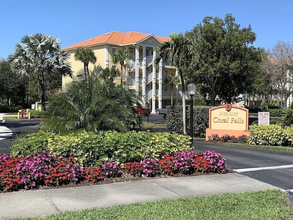 9185 Celeste Drive, Unit 101 Naples, FL 34113 - Photo 1 of 5 a view of a house with a yard and street