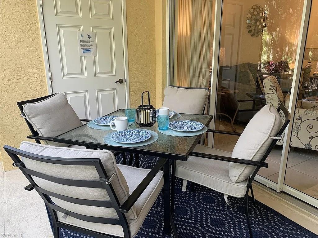 9185 Celeste Drive, Unit 101 Naples, FL 34113 - Photo 3 of 5 a view of a dining room with furniture