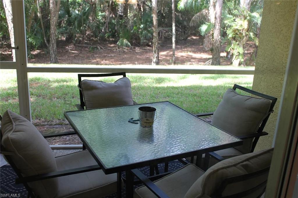 9185 Celeste Drive, Unit 101 Naples, FL 34113 - Photo 5 of 5 a view of a tables and chairs in patio