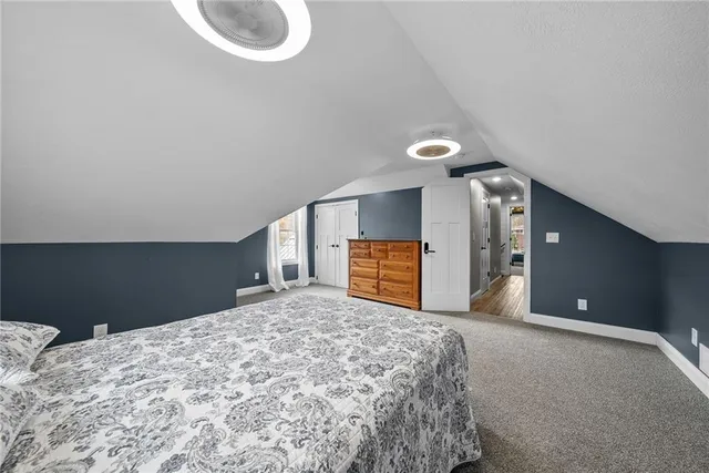 a view of a room with a bed and a chandelier