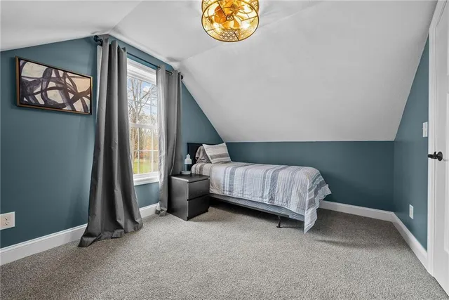 a bedroom with bed and a window