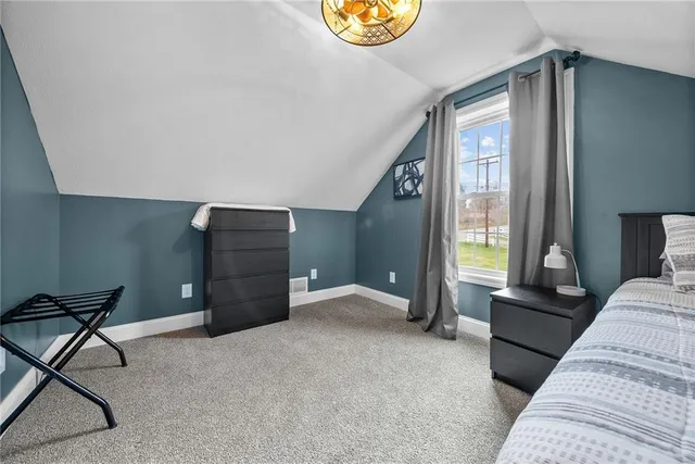 a bedroom with furniture and a window