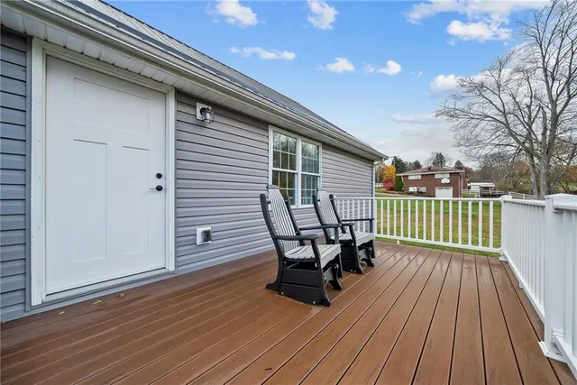 a view of a wooden deck with furniture