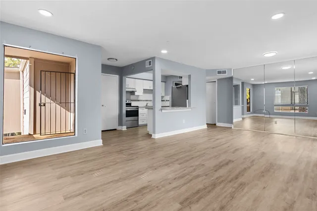 a view of a kitchen with a sink and a refrigerator
