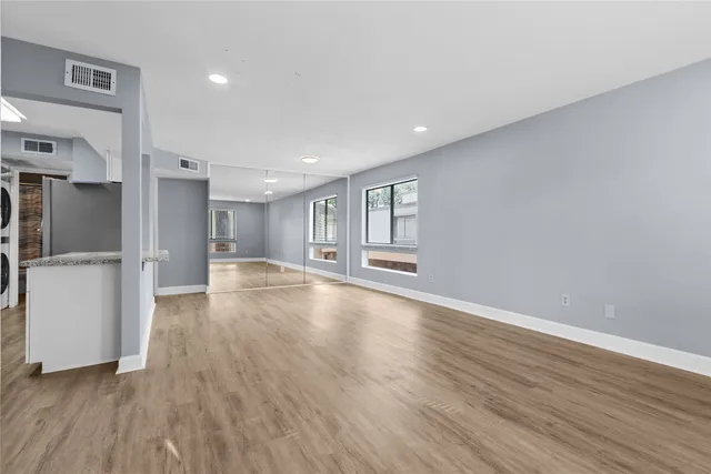 a view of empty room with wooden floor