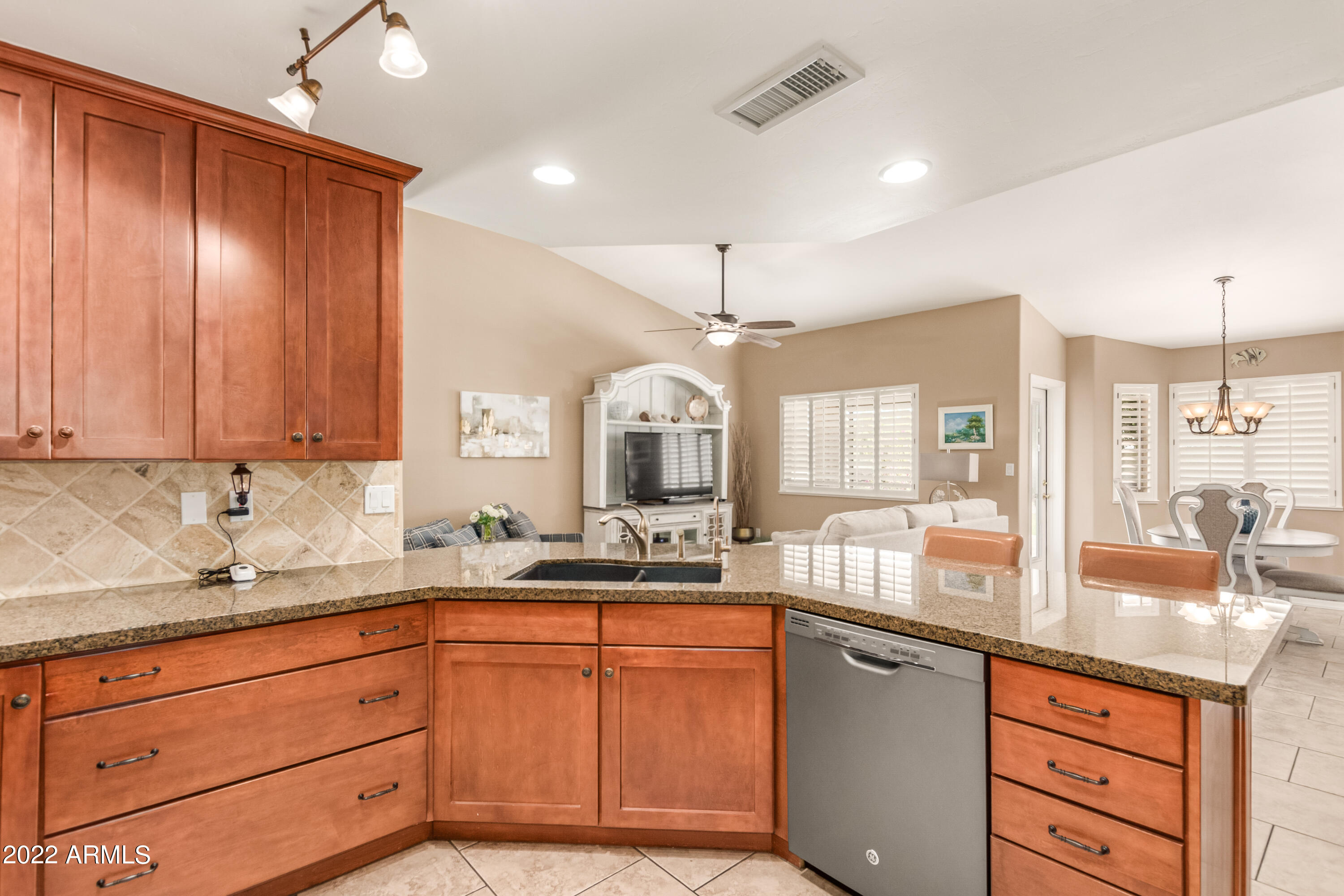 5830 East McKellips Road, Unit 76 Mesa, AZ 85215 - Photo 9 of 33 a kitchen with granite countertop wooden cabinets and white appliances
