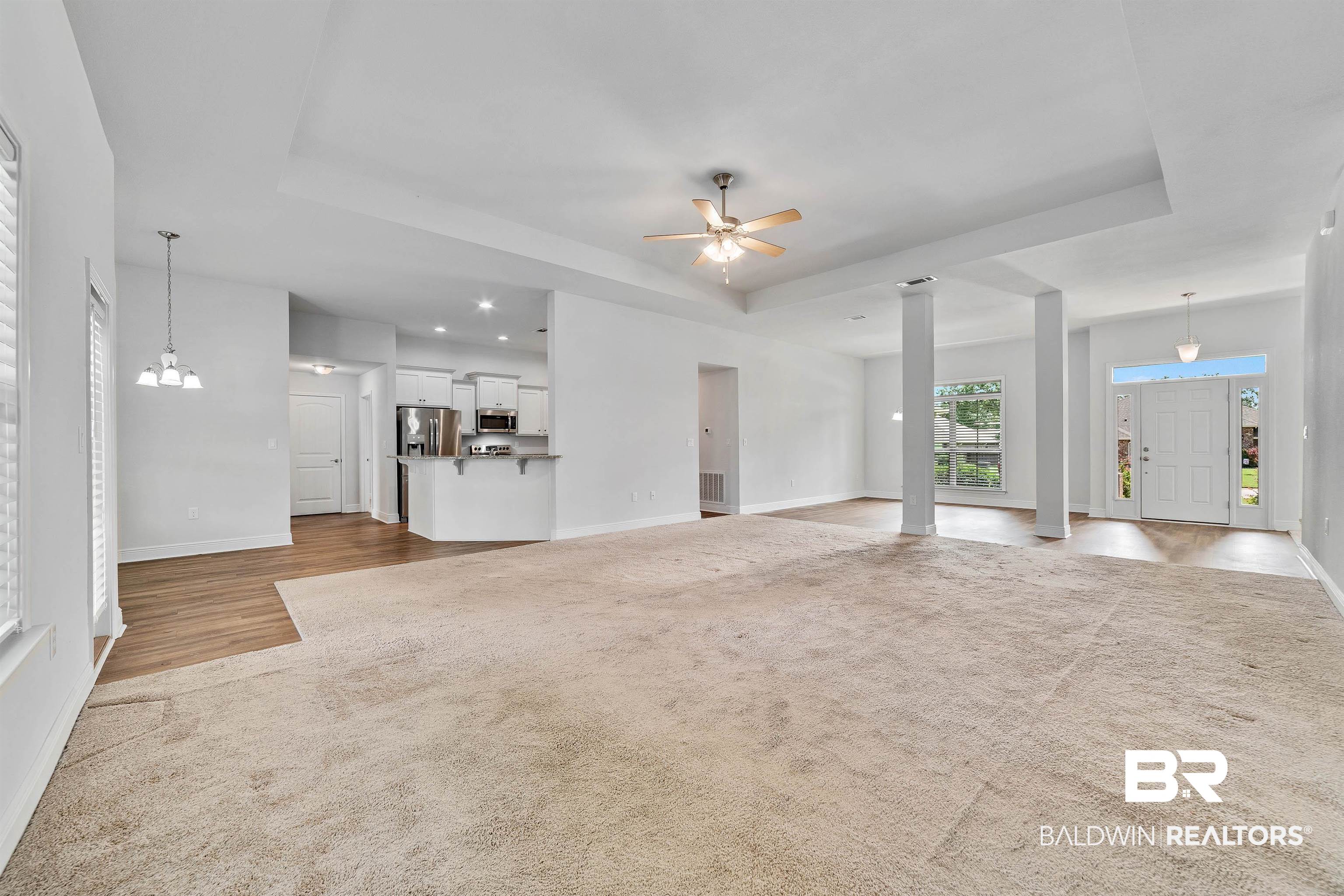 13155 Wishbone Court Foley, AL 36535 - Photo 6 of 39 Unfurnished living room featuring a raised ceiling and light colored carpet