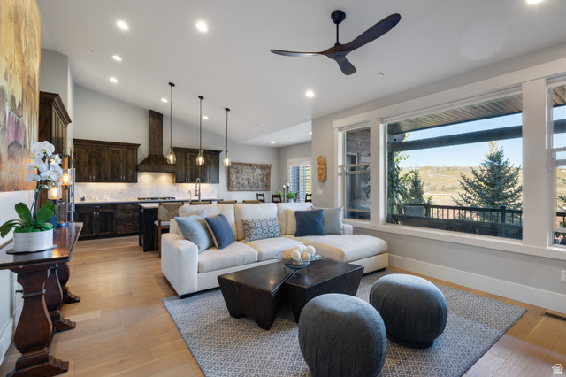 1737 East Viewside Circle Hideout, UT 84036 - Photo 6 of 35 Open-concept living space featuring wood-finish flooring, a vaulted ceiling with recessed lighting and a modern ceiling fan, and large windows