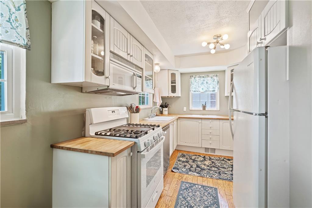 569 Kenilworth Drive Pittsburgh, PA 15228 - Photo 14 of 29 a kitchen with a cabinets and white appliances